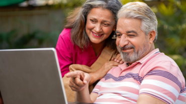 Indian senior couple using laptop. technology concept.
